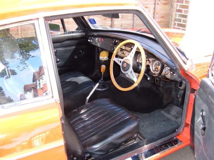 My 1970 MGB GT. Leather seats, a wooden steering wheel and gearknob, but otherwise fairly standard. Don&#039;t mind Hommer, he&#039;s good for clearing the windscreen when it mists up!For more pics see my website, which is linked from the links page.