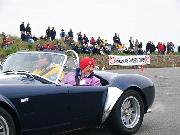 Peter De Rousset-Hall from Surrey in his AC Cobra, burning rubber with Dizzy as passenger.The car is the last ever genuine AC Cobra to be built. It will be here again next year for the Silver Jubilee.