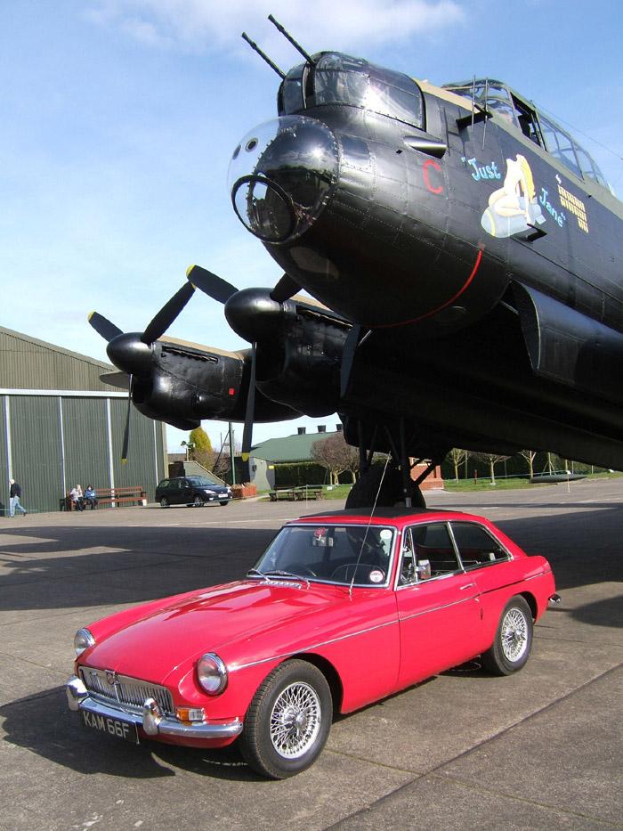 1967 MGB GT &#039;Kamilla&#039; with Avro Lancaster NX611 &#039;Just Jane&#039; at the Lincolnshire Aviation Heritage Centre, East Kirby