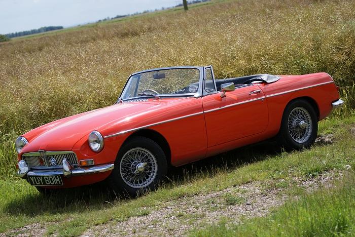 My 1969 MGB, Blaze red (hence the pun), basking in the sun.  Taken in the summer-time, around July, I remember the day was sublime.  BLAST!! I&#039;m talking in rhyme!